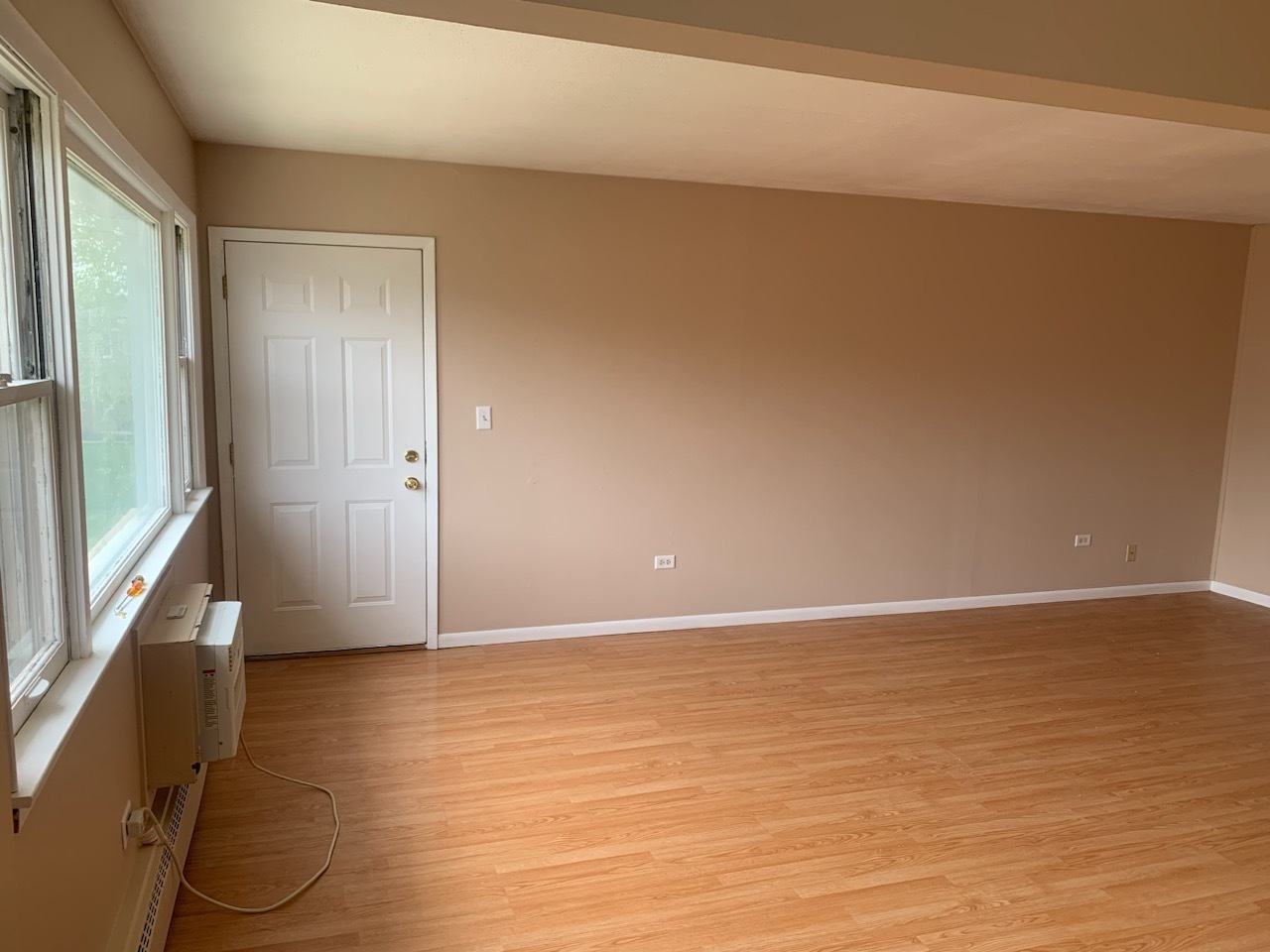 239 Northway Park Road, Unit 12 Machesney Park, IL 61115 - Photo 3 of 15 a view of an empty room with wooden floor and a window