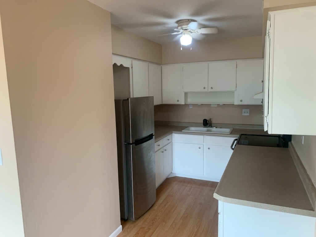 239 Northway Park Road, Unit 12 Machesney Park, IL 61115 - Photo 6 of 15 a kitchen with a refrigerator sink and cabinets