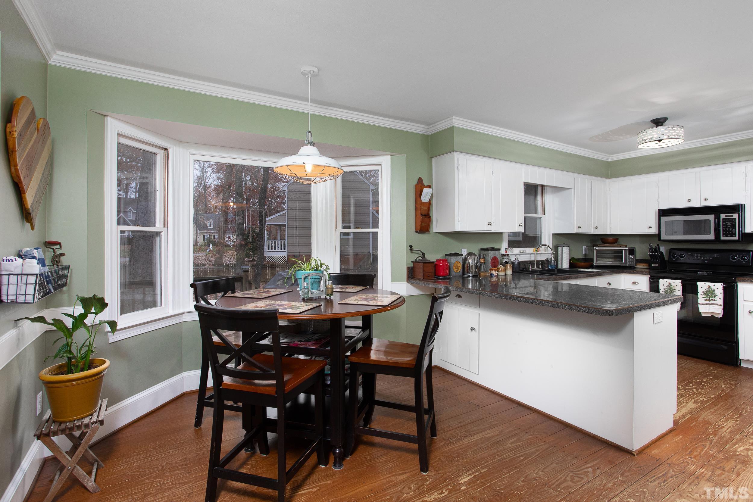 2501 Diamondhitch Trail Raleigh, NC 27615 - Photo 12 of 21 a view of a dining room with furniture and a kitchen