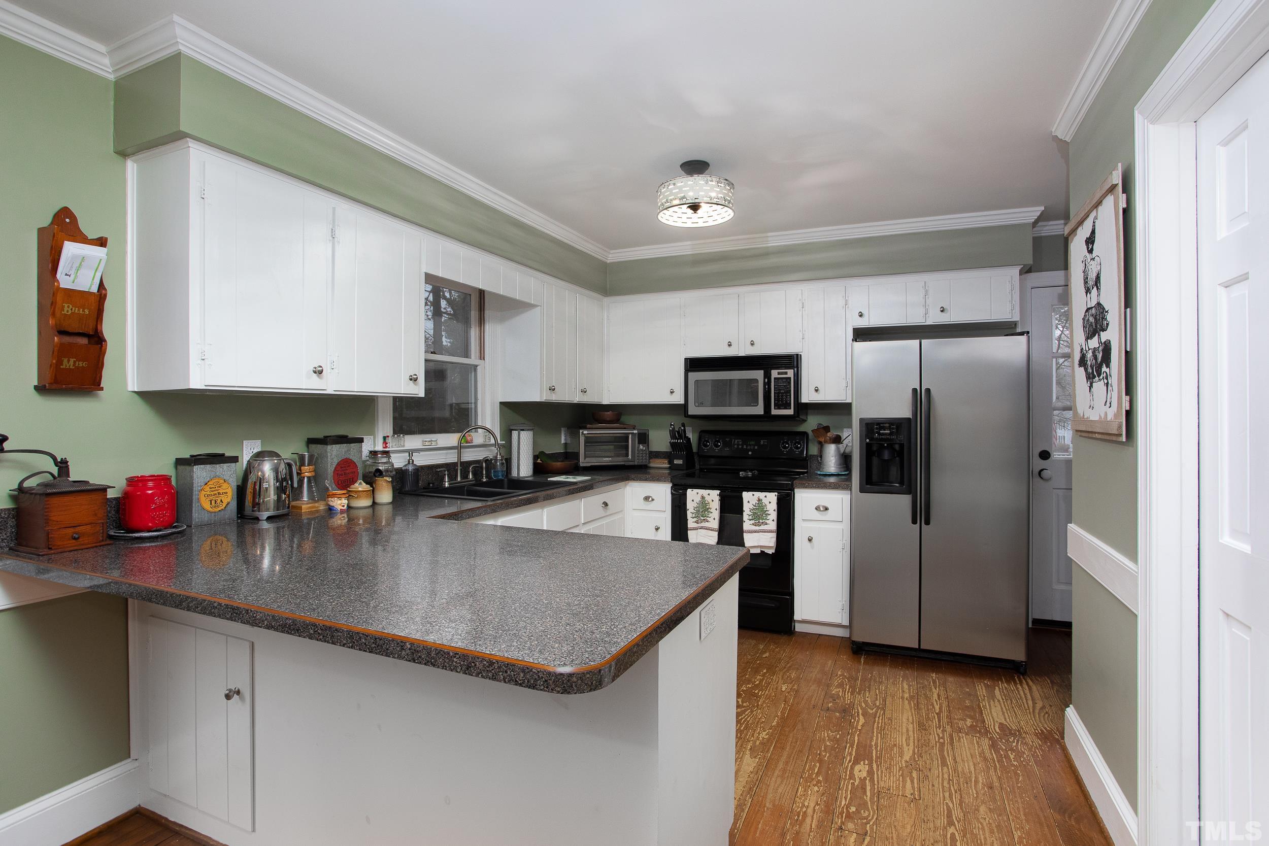 2501 Diamondhitch Trail Raleigh, NC 27615 - Photo 13 of 21 a kitchen with stainless steel appliances granite countertop a refrigerator a sink dishwasher a stove and a refrigerator with wooden floor