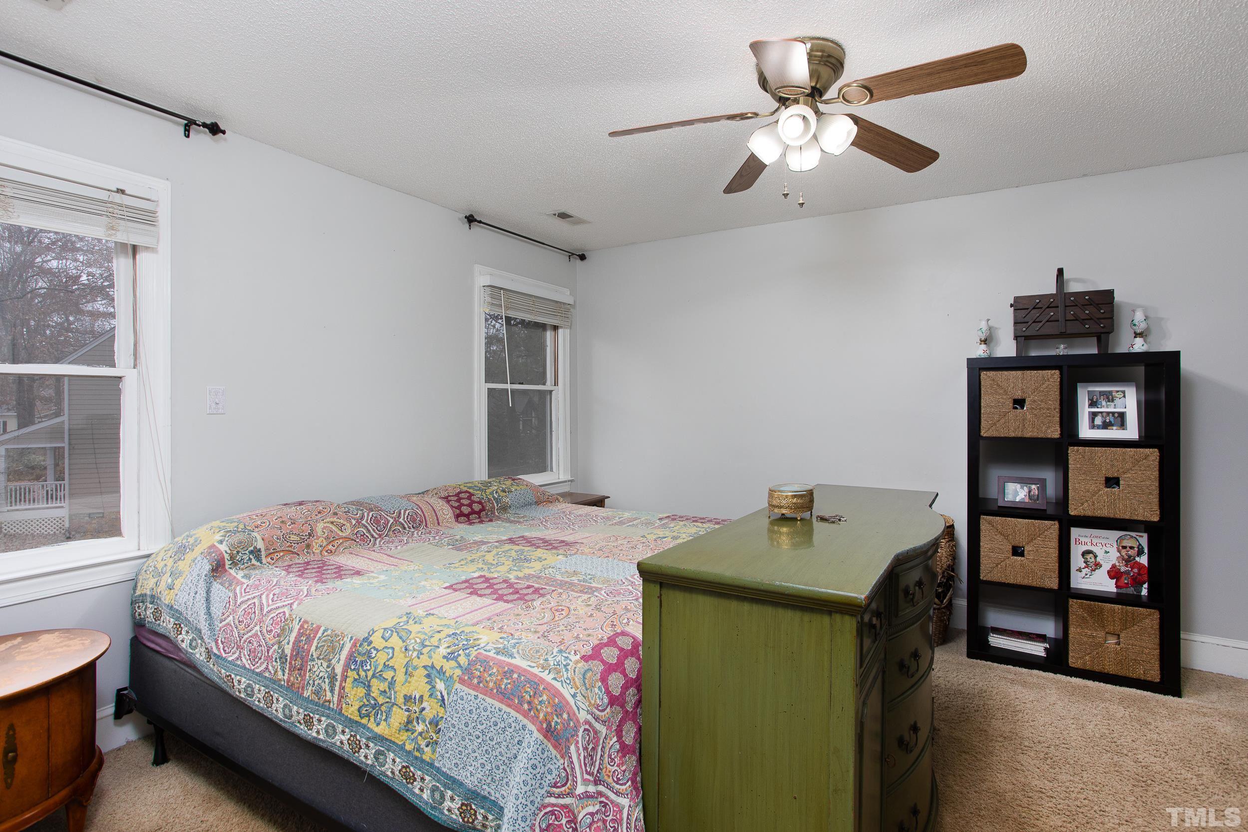 2501 Diamondhitch Trail Raleigh, NC 27615 - Photo 16 of 21 a bedroom that has a bed and a chandelier