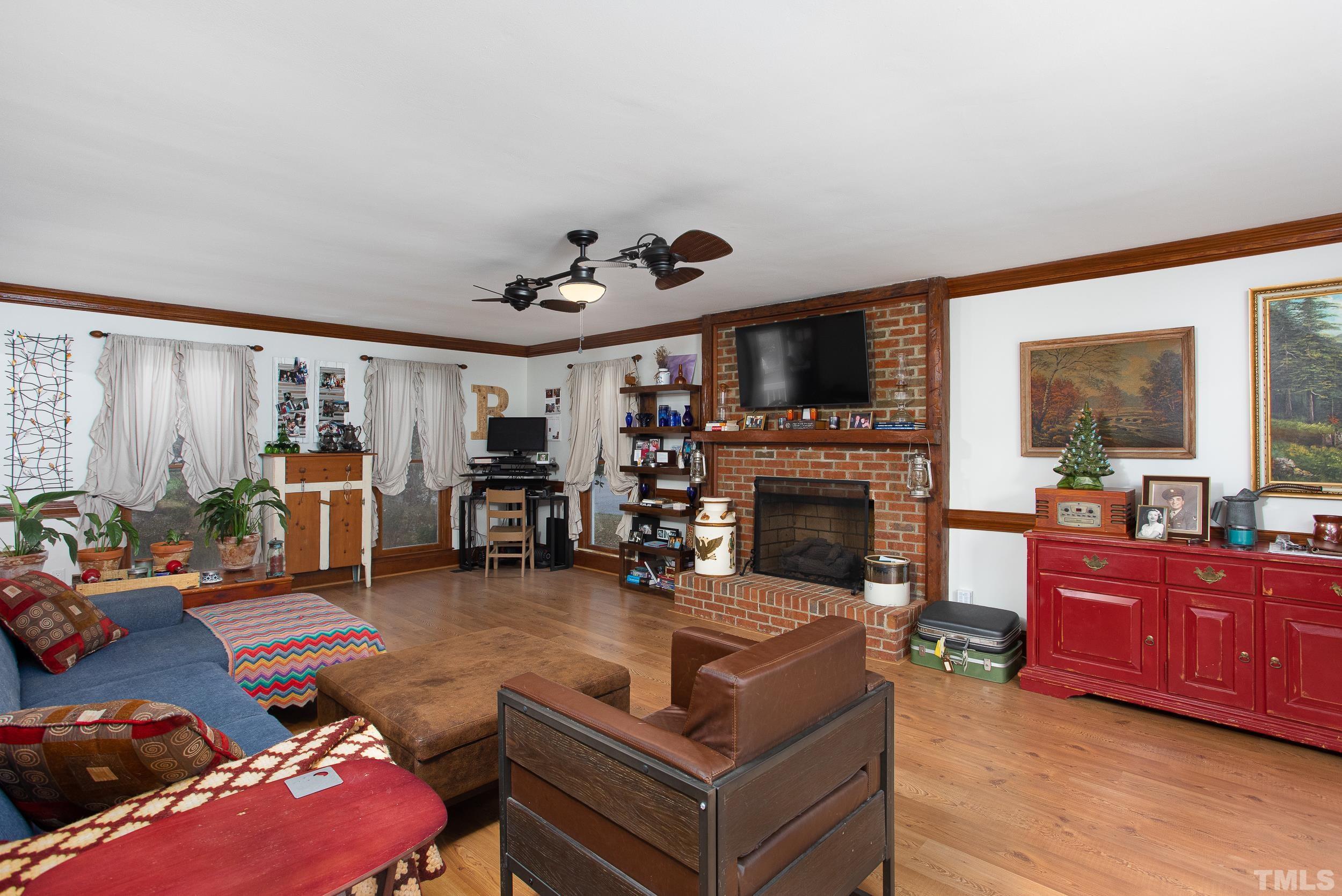 2501 Diamondhitch Trail Raleigh, NC 27615 - Photo 10 of 21 a living room with furniture a flat screen tv and a fireplace