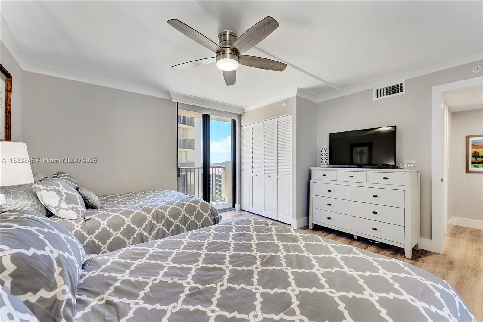 200 Ocean Trail Way, Unit 701 Jupiter, FL 33477 - Photo 23 of 27 a bedroom with a bed and flat screen tv