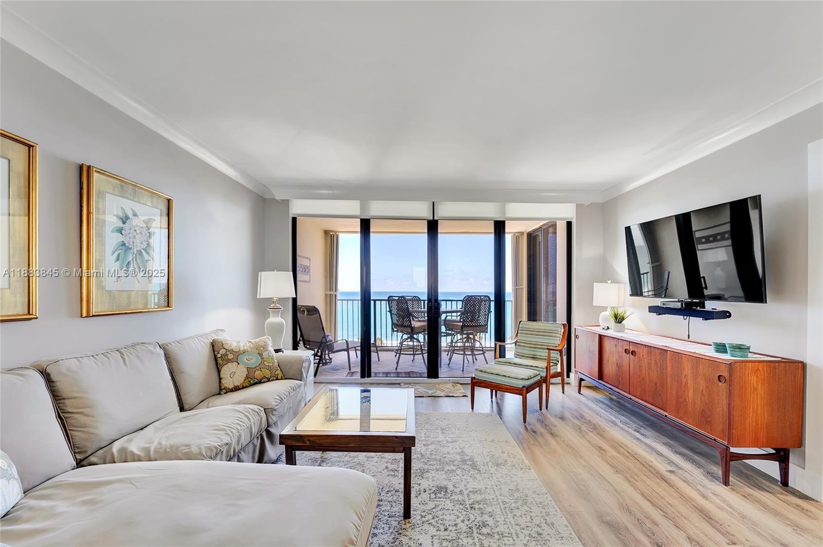 200 Ocean Trail Way, Unit 701 Jupiter, FL 33477 - Photo 4 of 27 a living room with furniture and a flat screen tv