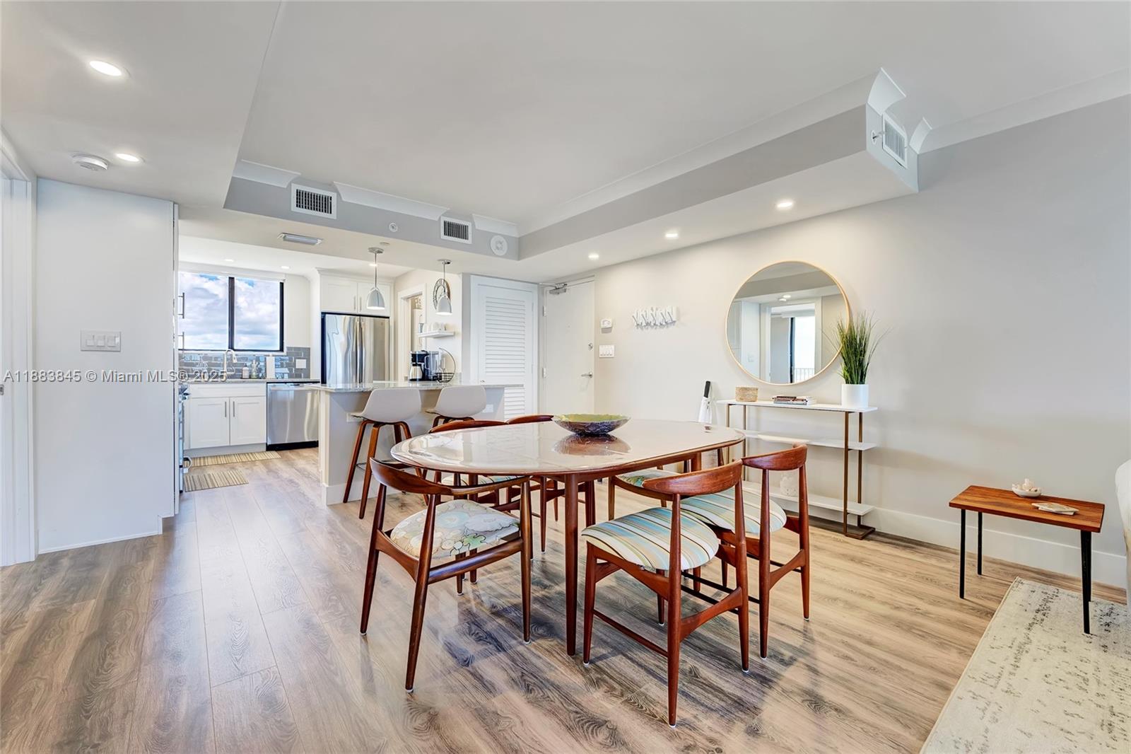 200 Ocean Trail Way, Unit 701 Jupiter, FL 33477 - Photo 7 of 27 a view of a dining room with furniture and wooden floor