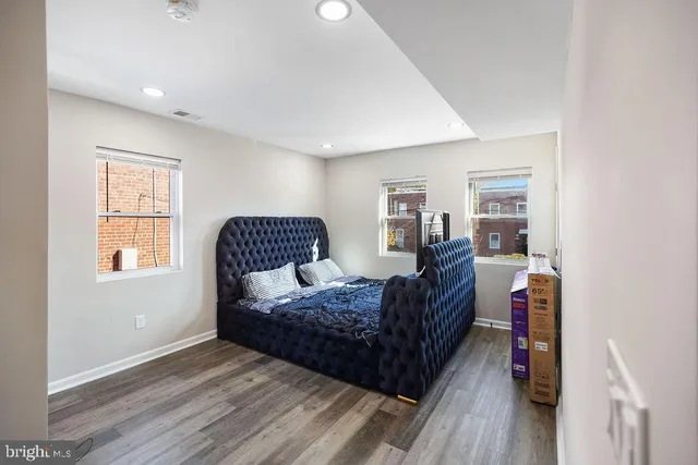 a living room with a bed furniture and a window