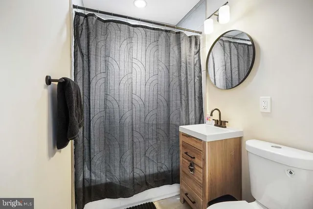 a bathroom with a sink a mirror and a shower curtain