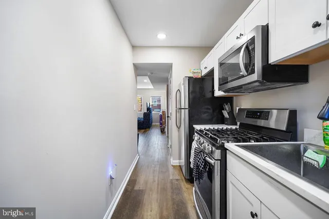 a kitchen with stainless steel appliances a stove a microwave and a refrigerator