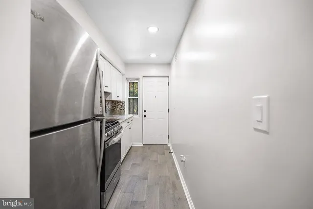 a kitchen with a refrigerator and a sink