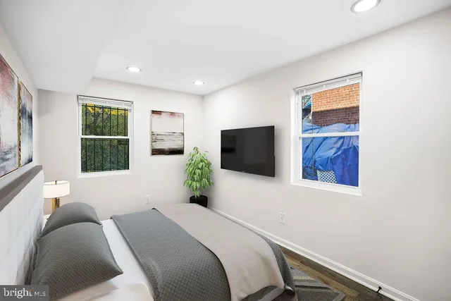 a bedroom with a bed and a flat screen tv