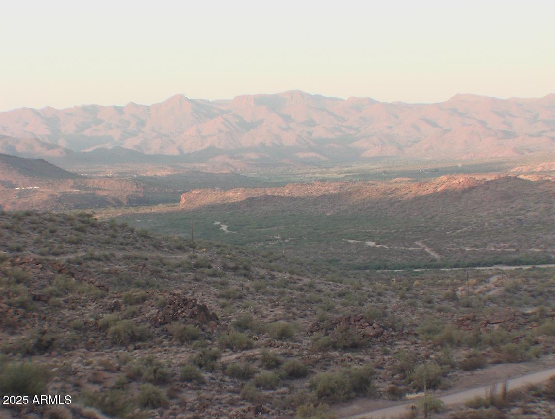 0 Higland Road Wikieup, AZ 85360 - Photo 3 of 3 a view of a dry yard with mountains in the background