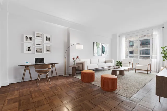 a living room with furniture a fireplace and large windows