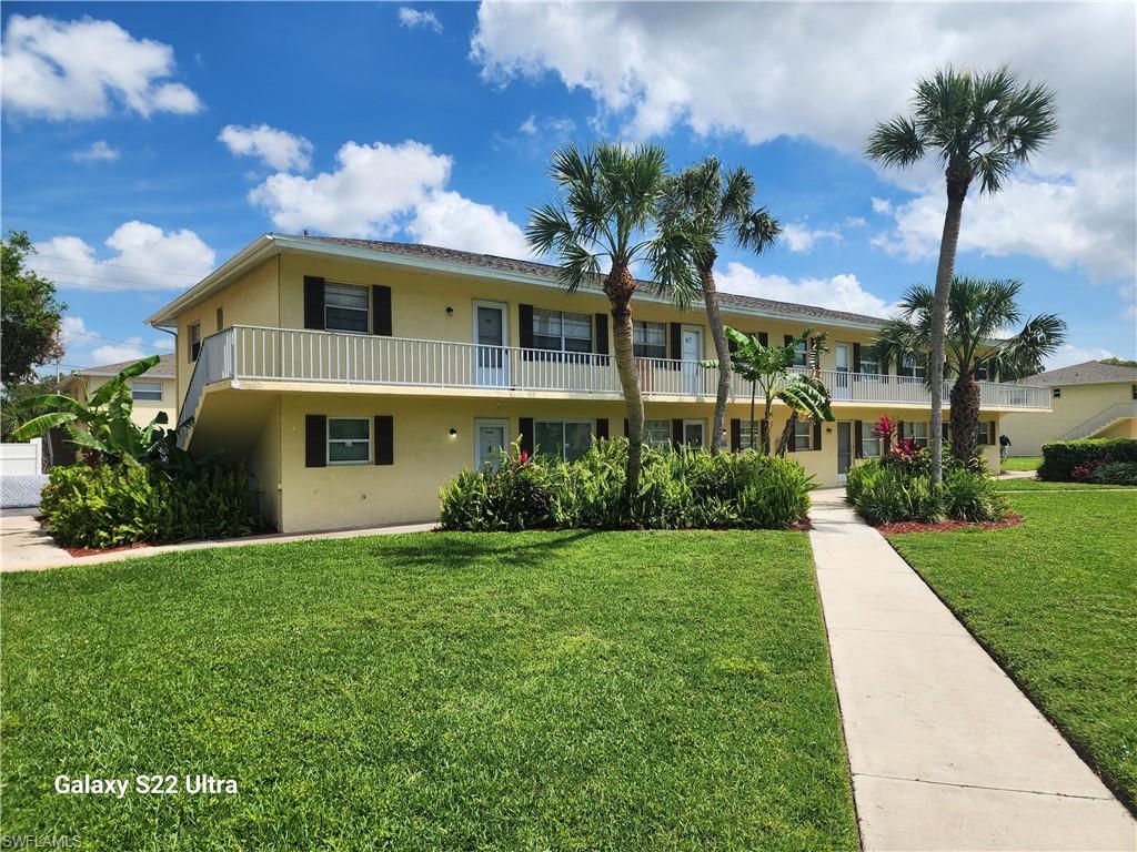 3325 Airport Road North, Unit N8 Naples, FL 34105 - Photo 2 of 22 a front view of a house with a yard