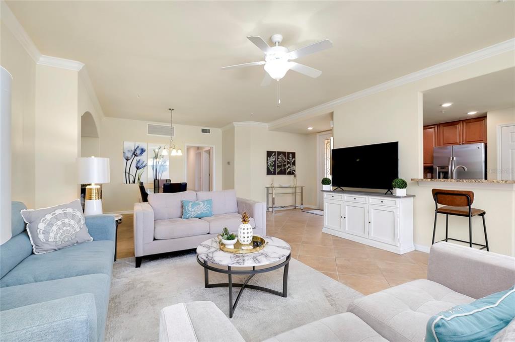 20100 Ragazza Circle, Unit 101 Venice, FL 34293 - Photo 17 of 100 a living room with furniture and a flat screen tv