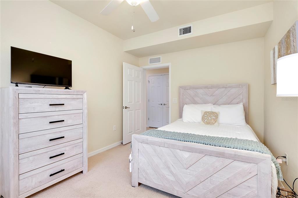 20100 Ragazza Circle, Unit 101 Venice, FL 34293 - Photo 50 of 100 a bedroom with a bed and a television