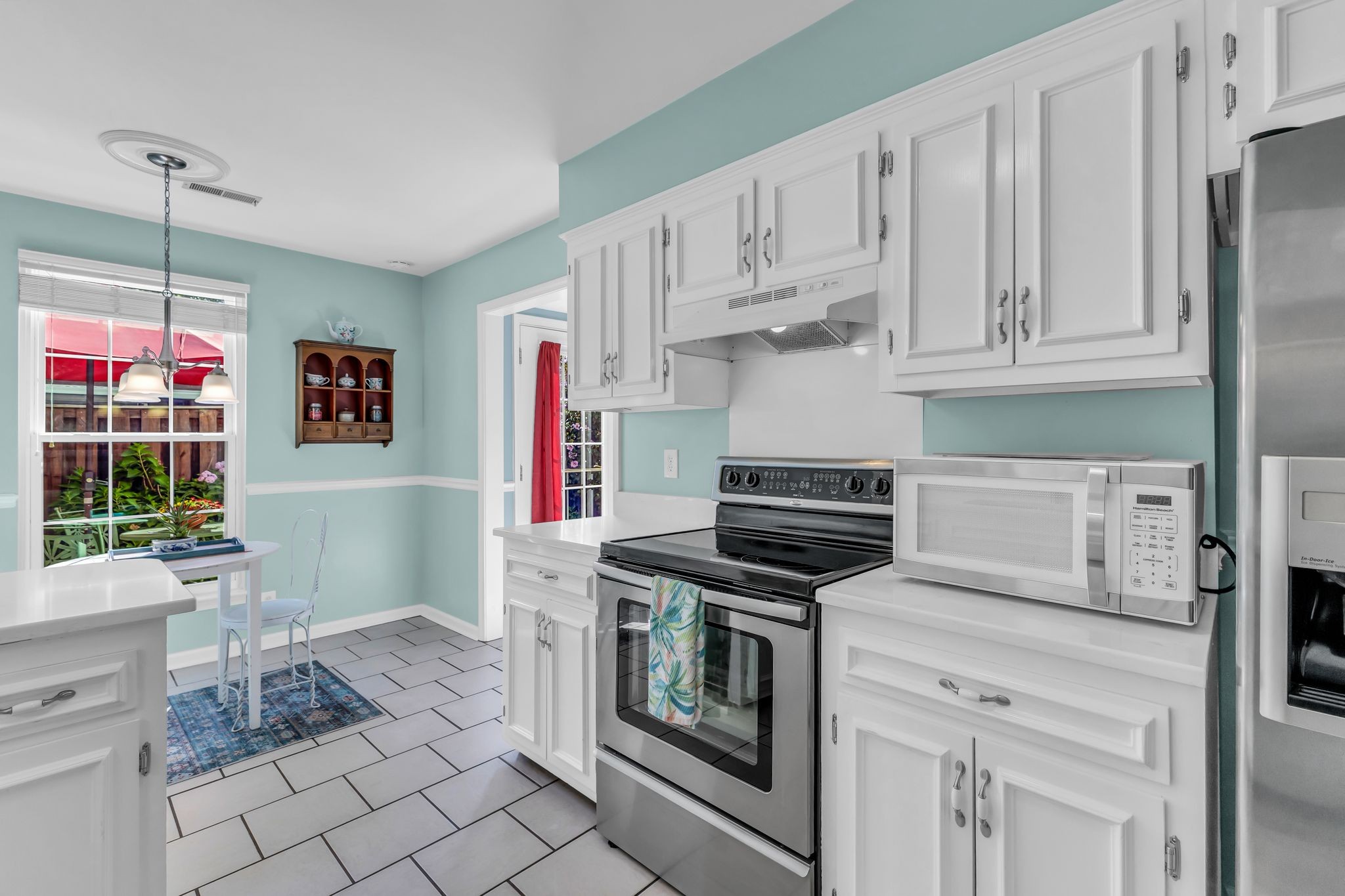 824 General George Patton Road Nashville, TN 37221 - Photo 19 of 35 a kitchen with white cabinets and appliances