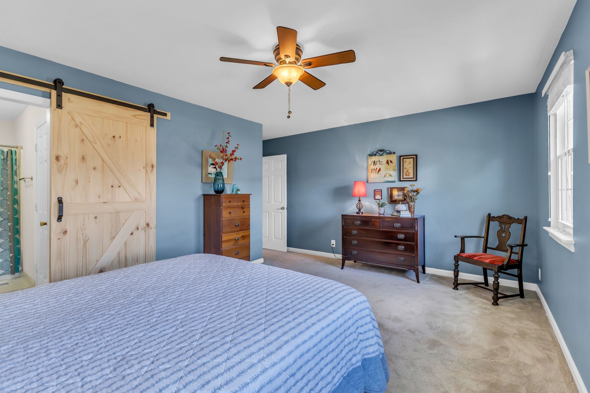 824 General George Patton Road Nashville, TN 37221 - Photo 24 of 35 a bedroom with a bed and a chandelier