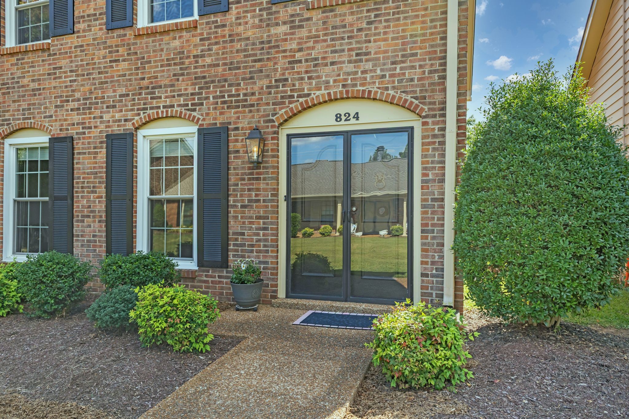 824 General George Patton Road Nashville, TN 37221 - Photo 5 of 35 a view of a brick house with a large windows and plants
