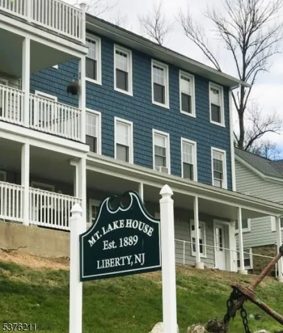 a front view of a residential apartment building with a yard