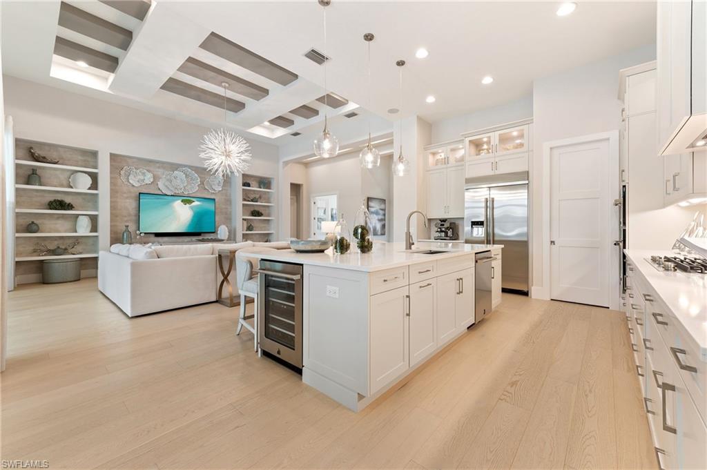 8916 Nevis Way Naples, FL 34112 - Photo 11 of 50 a large white kitchen with a sink and dishwasher a oven with white cabinets