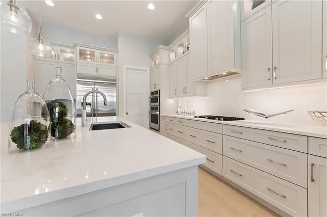a kitchen with granite countertop a white stove top oven and cabinets