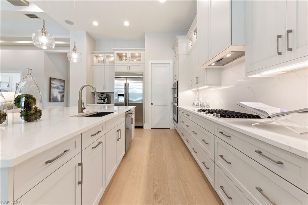 8916 Nevis Way Naples, FL 34112 - Photo 14 of 50 a large kitchen with granite countertop lots of counter space and window