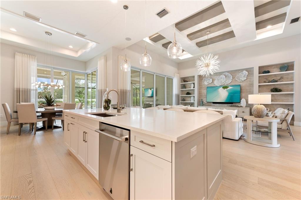 8916 Nevis Way Naples, FL 34112 - Photo 16 of 50 a large white kitchen with a large window and chairs