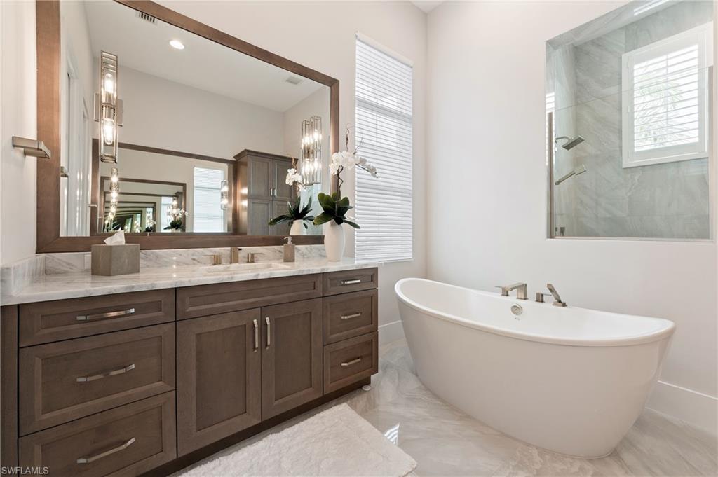 8916 Nevis Way Naples, FL 34112 - Photo 21 of 50 a spacious bathroom with a double vanity sink mirror and double