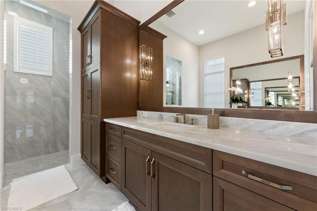 8916 Nevis Way Naples, FL 34112 - Photo 22 of 50 a bathroom with a granite countertop sink mirror and double