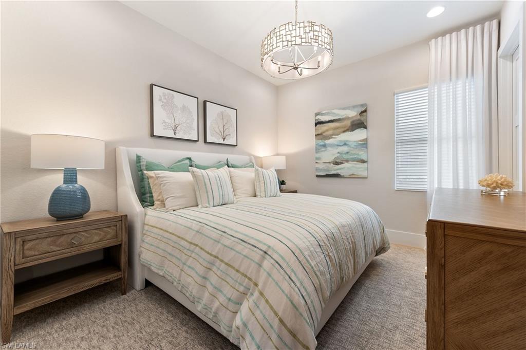 8916 Nevis Way Naples, FL 34112 - Photo 29 of 50 a bedroom with bed and a chandelier
