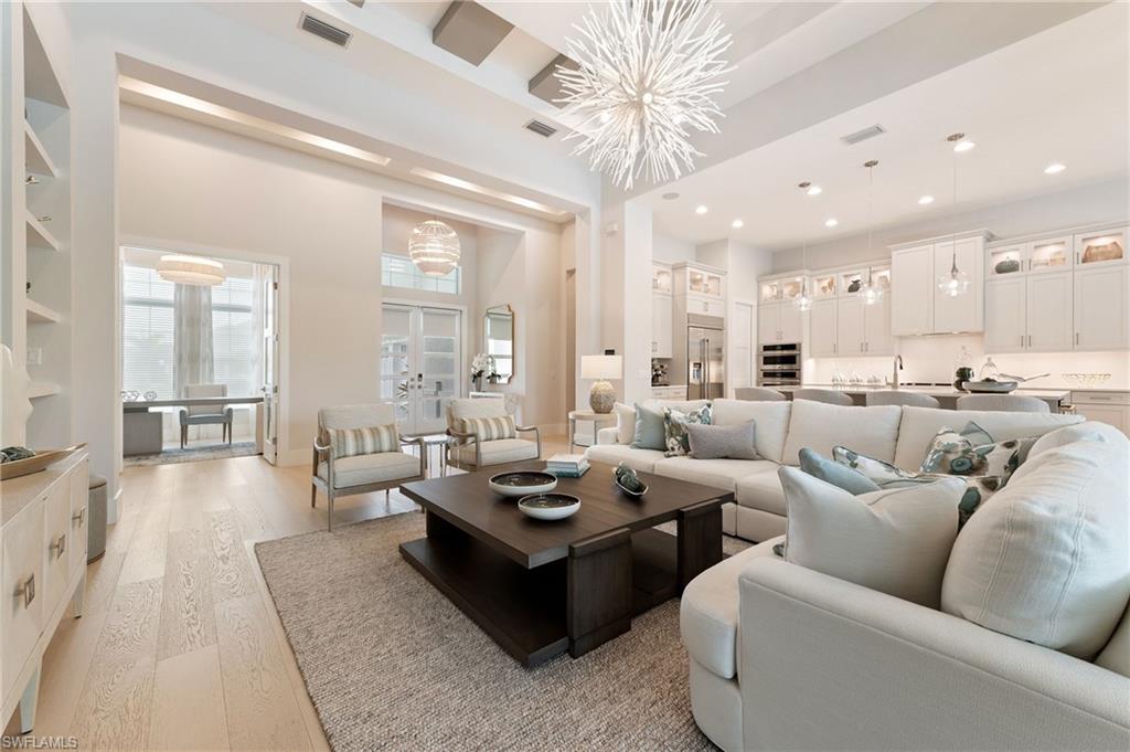 8916 Nevis Way Naples, FL 34112 - Photo 3 of 50 a living room with furniture wooden floor and a large window