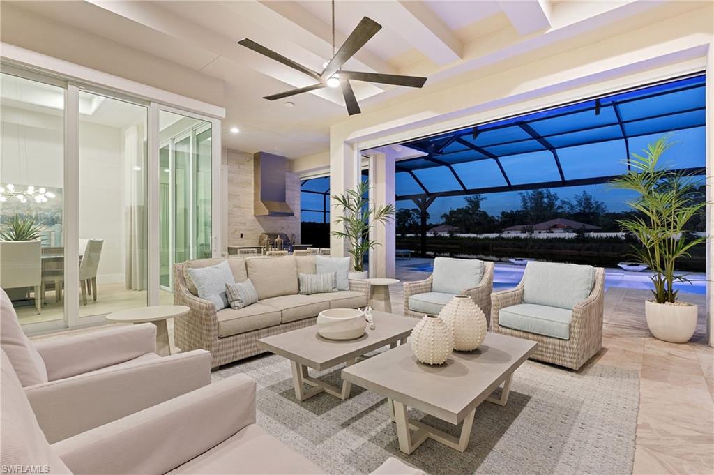 8916 Nevis Way Naples, FL 34112 - Photo 33 of 50 a living room with furniture a chandelier and a table