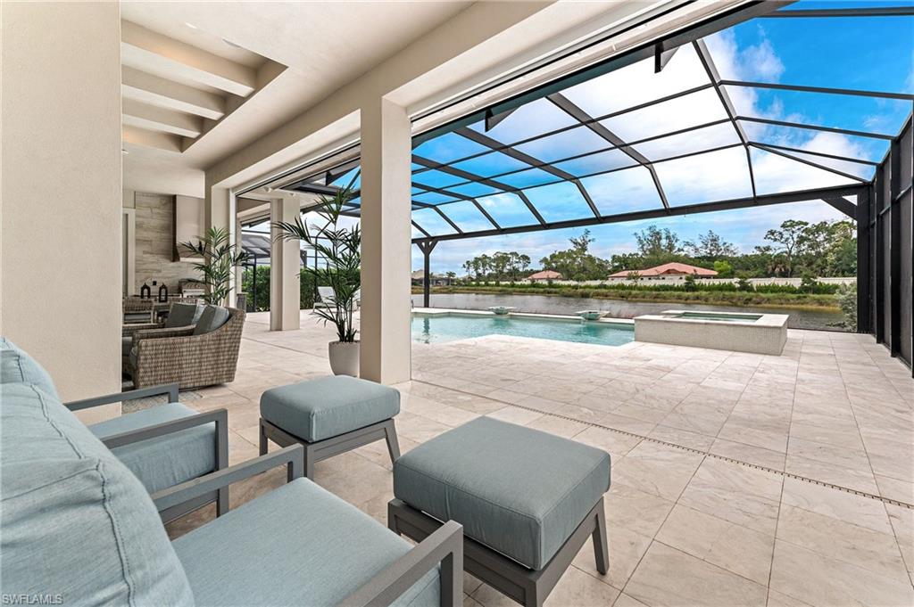 8916 Nevis Way Naples, FL 34112 - Photo 36 of 50 a living room with furniture and a floor to ceiling window