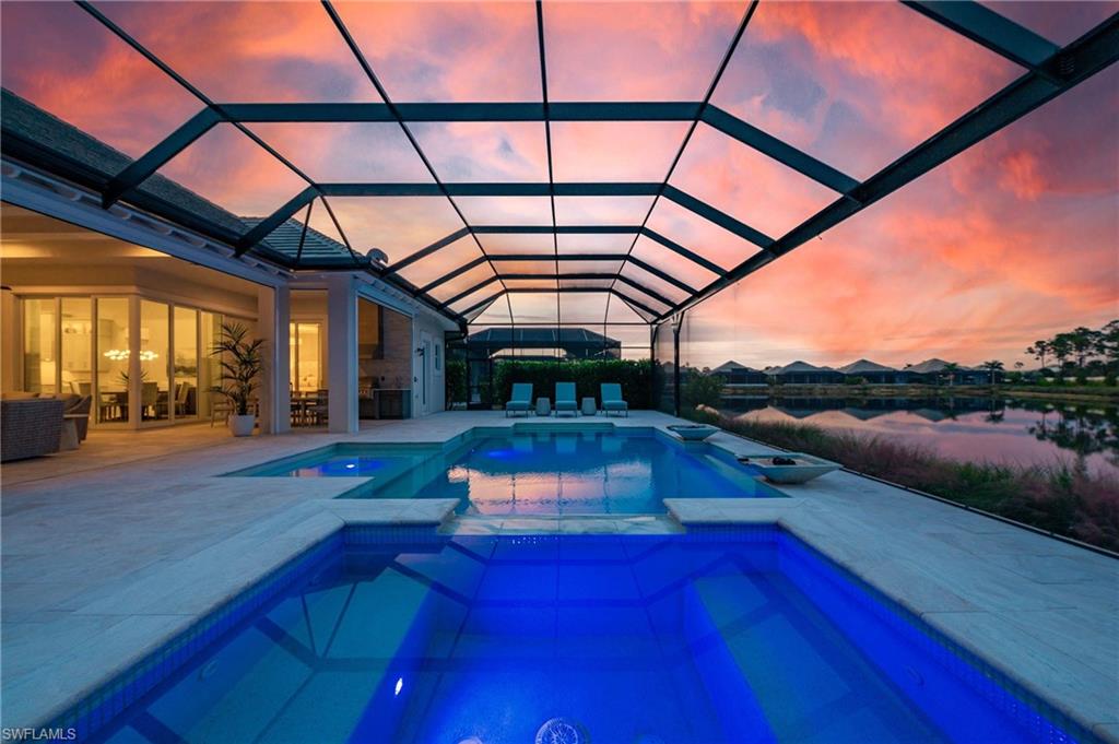 8916 Nevis Way Naples, FL 34112 - Photo 38 of 50 a living room with furniture and a floor to ceiling window