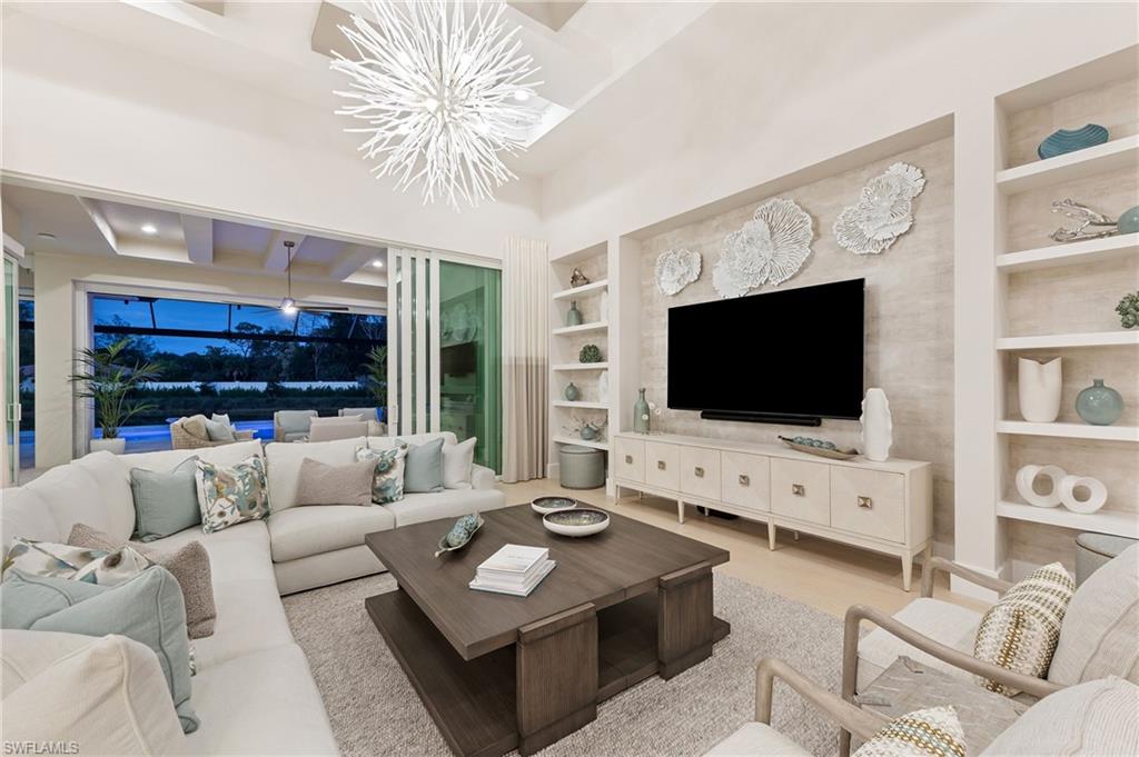 8916 Nevis Way Naples, FL 34112 - Photo 4 of 50 a living room with furniture and a flat screen tv