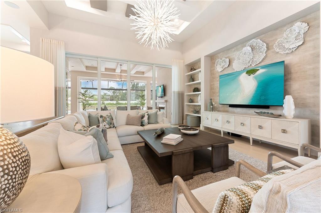 8916 Nevis Way Naples, FL 34112 - Photo 7 of 50 a living room with furniture and a flat screen tv