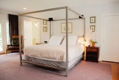 a bed room with a bed and a chair