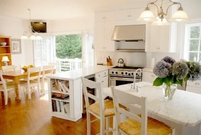 a kitchen with furniture and a large window
