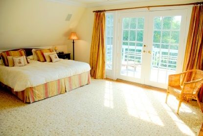 Undisclosed Address Bridgehampton, NY 11976 - Photo 8 of 19 a spacious bedroom with a bed and a large window