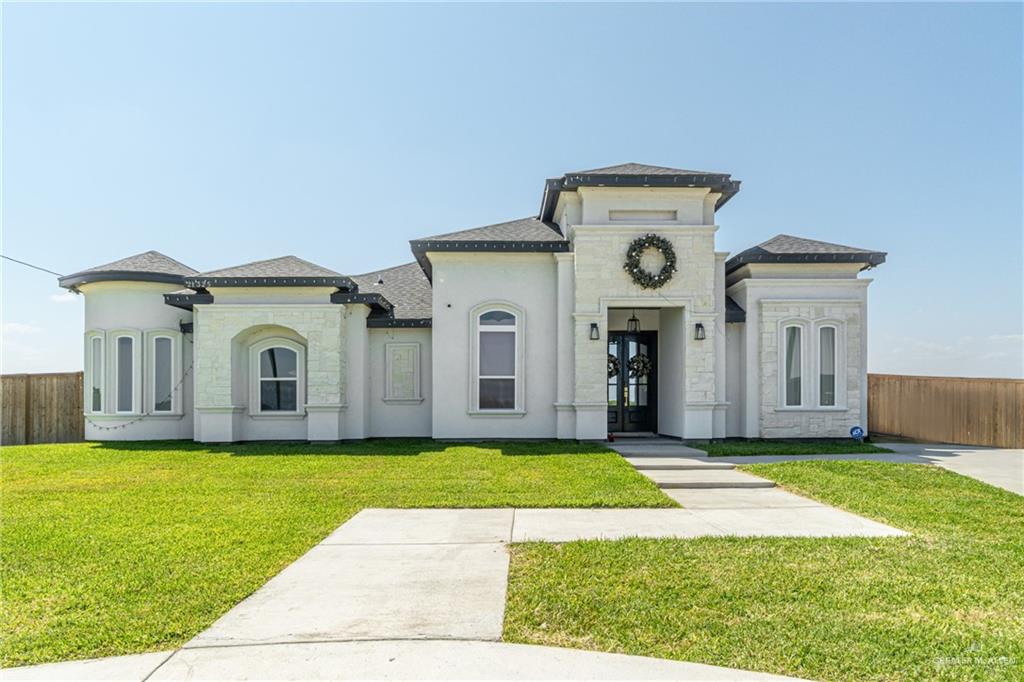 21325 Hibiscus Street Edcouch, TX 78538 - Photo 1 of 17 a view of a house with a big yard and large trees