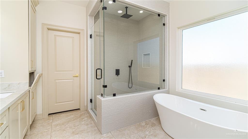 21325 Hibiscus Street Edcouch, TX 78538 - Photo 11 of 17 a bathroom with a tub a sink and a shower