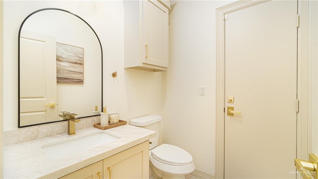 21325 Hibiscus Street Edcouch, TX 78538 - Photo 7 of 17 a bathroom with a sink a toilet and a mirror