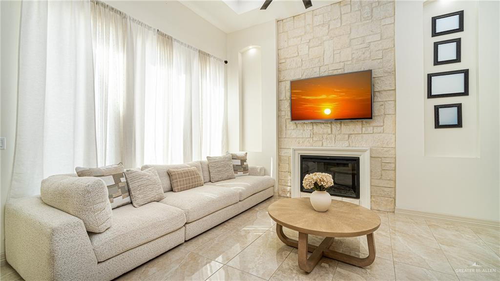 21325 Hibiscus Street Edcouch, TX 78538 - Photo 8 of 17 a living room with furniture a fireplace and a flat screen tv
