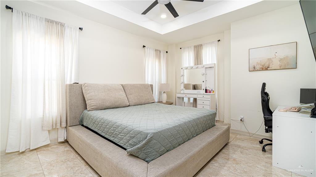 21325 Hibiscus Street Edcouch, TX 78538 - Photo 10 of 17 a bedroom with a bed and a chandelier