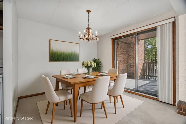 a dining room with furniture a chandelier and a rug