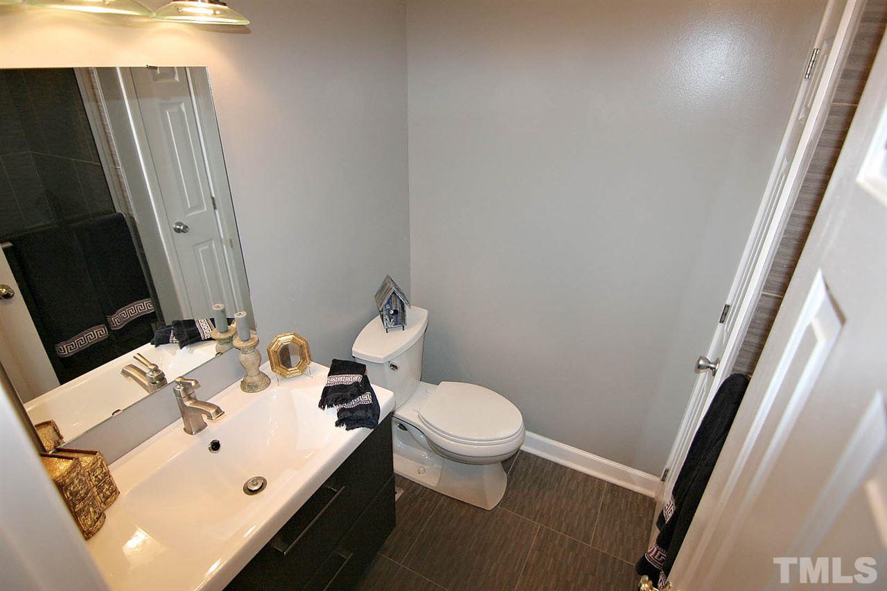 4530 Hamptonshire Drive Raleigh, NC 27613 - Photo 10 of 20 a white toilet sitting next to a bathroom sink