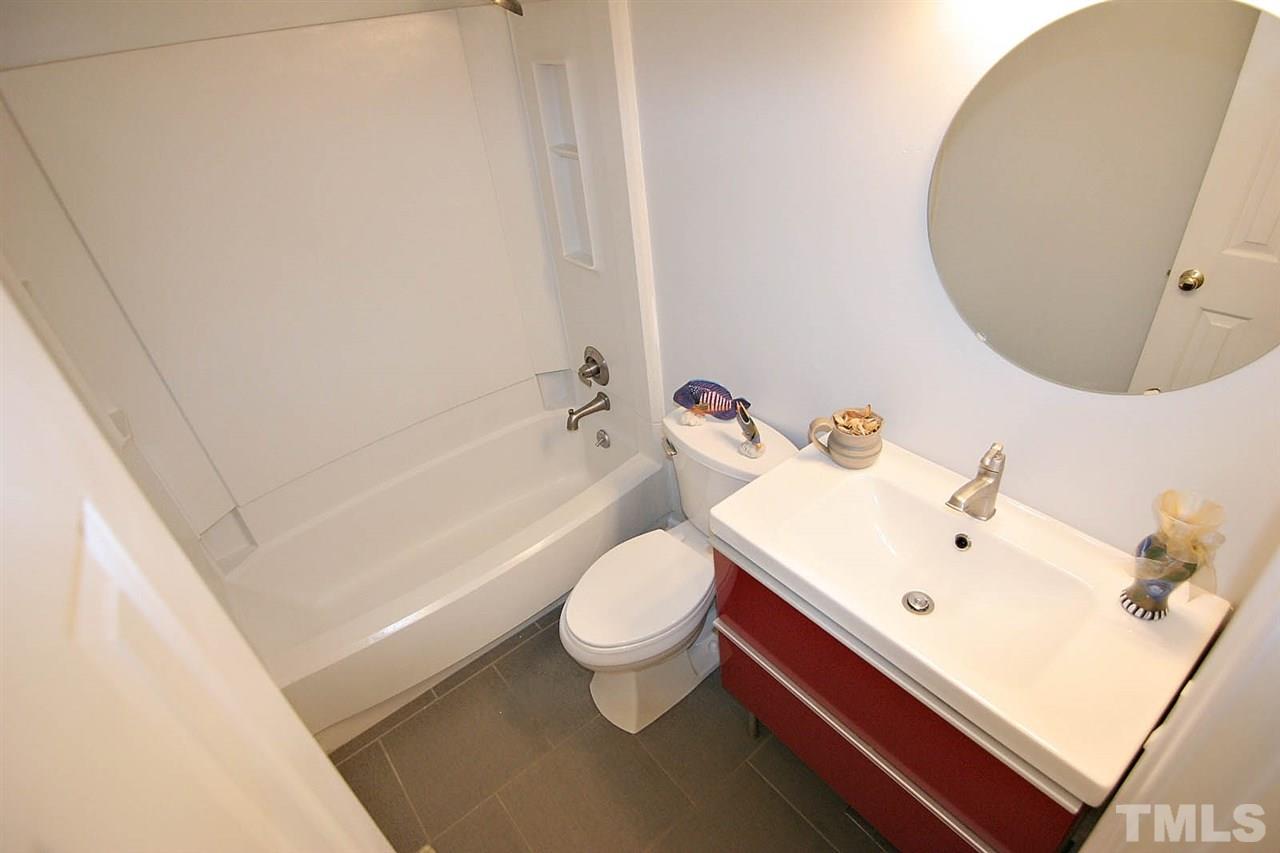 4530 Hamptonshire Drive Raleigh, NC 27613 - Photo 12 of 20 a white toilet sitting next to a bathroom sink