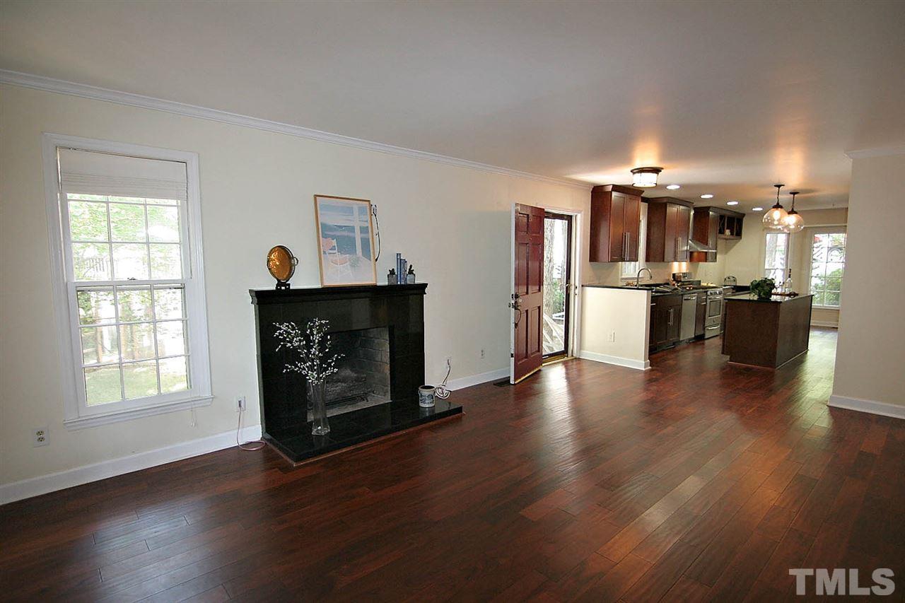 4530 Hamptonshire Drive Raleigh, NC 27613 - Photo 20 of 20 a living room with stainless steel appliances wooden floors and fireplace