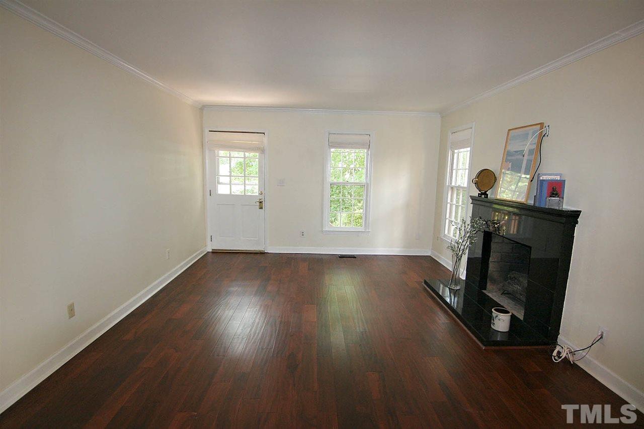 4530 Hamptonshire Drive Raleigh, NC 27613 - Photo 2 of 20 a view of an empty room with wooden floor and a window