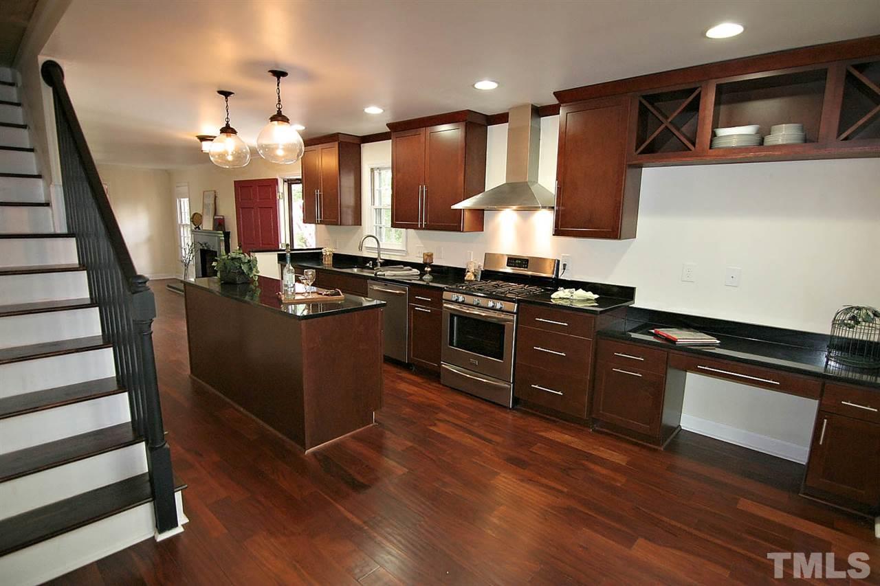 4530 Hamptonshire Drive Raleigh, NC 27613 - Photo 6 of 20 a kitchen with stainless steel appliances granite countertop a stove a sink dishwasher and a microwave oven with cabinets